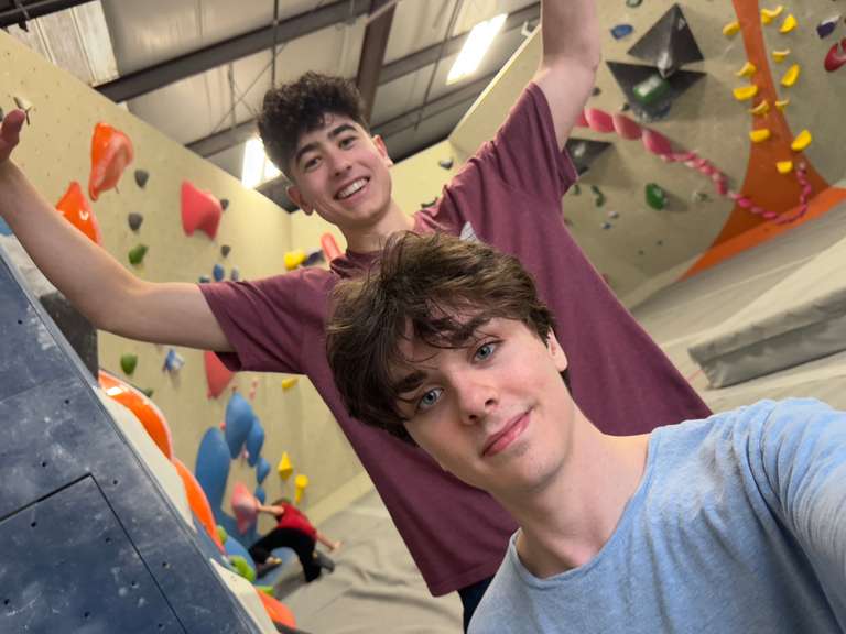 James Gerhard and friend rock climbing.